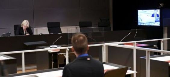 Seen on a court video link screen, right, Moroccan man Abderrahman Mechkah, lays in a hospital bed during the initial remand hearing. Photograph: Martti Kainulainen/Lehtikuva/AP Seen on a court video link screen, right, Moroccan man Abderrahman Mechkah, l