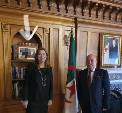 The Algerian and Swedish ambassadors standing before a blurred photo that shows King Mohammed VI and the Algerian diplomat. / DR