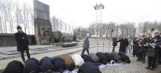 Muslim scholars perform Islamic prayers during a visit to Auschwitz. / DR